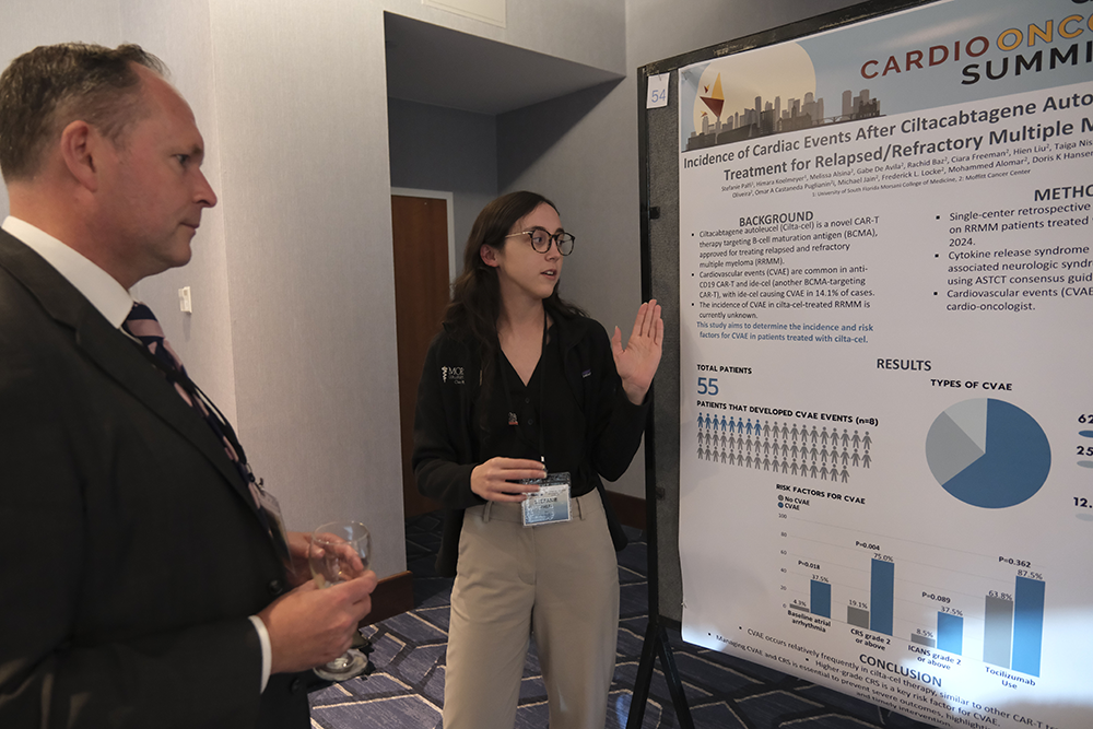 Stephanie Palfi, right, presents a poster to Dr Alexander Lyon at GCOS 2024