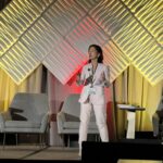 GYKq6amWIAAGw51 Bonnie Ky, an Asian woman wearing a white suit, talks at GCOS 2024