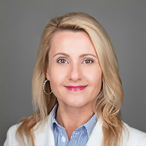 Lisa Nodzon, a white woman with long blonde hair in a lab coat